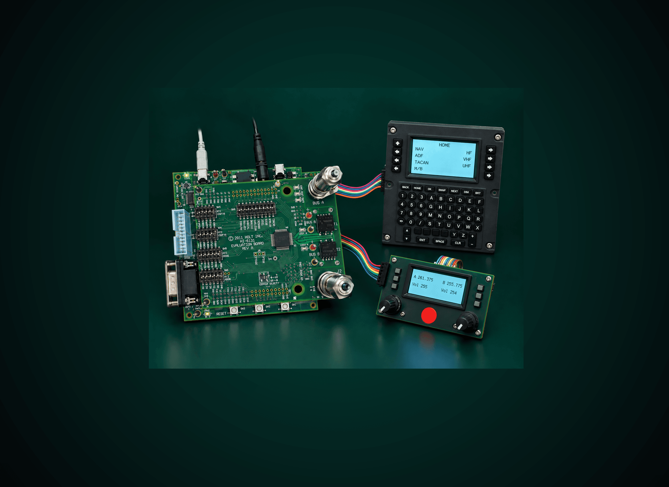 A Holt HI-6131 MIL-STD-1553 evaluation board wired over dual-redundant Bus A/Bus B ribbon cables to a CDU control display unit and a dual-frequency radio control panel
